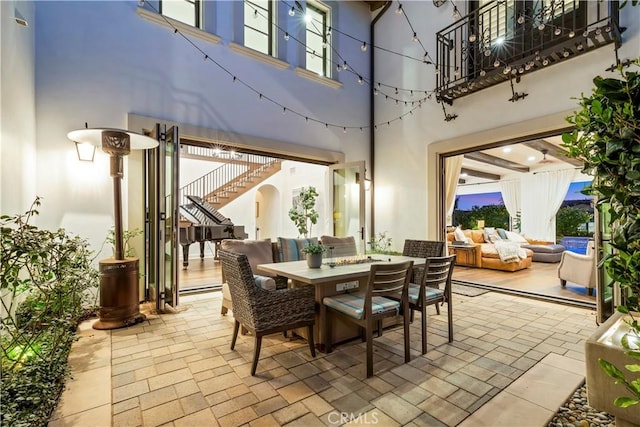 view of patio featuring outdoor dining space, an outdoor living space, and stairs