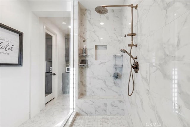 bathroom featuring a marble finish shower