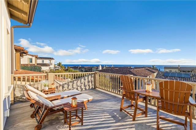 wooden terrace featuring a water view