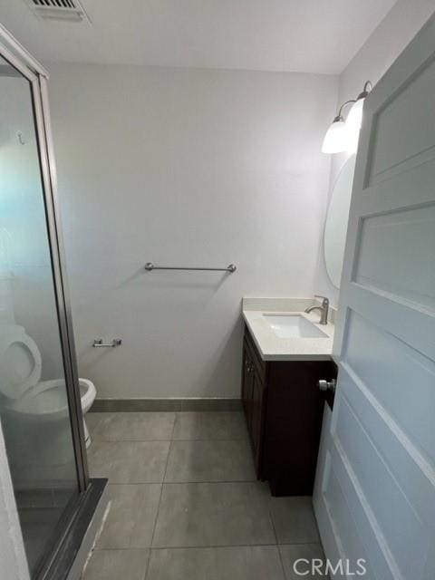 full bathroom with vanity, visible vents, a stall shower, tile patterned flooring, and toilet