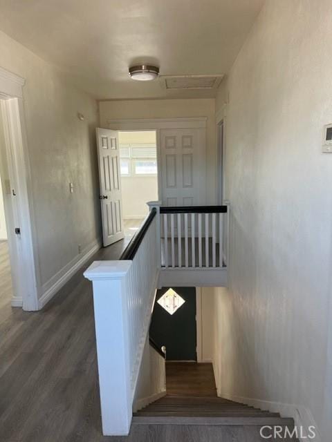 staircase with baseboards and wood finished floors