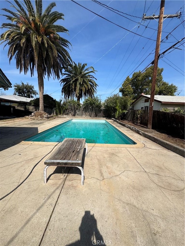 view of pool with a patio area, a fenced in pool, and fence