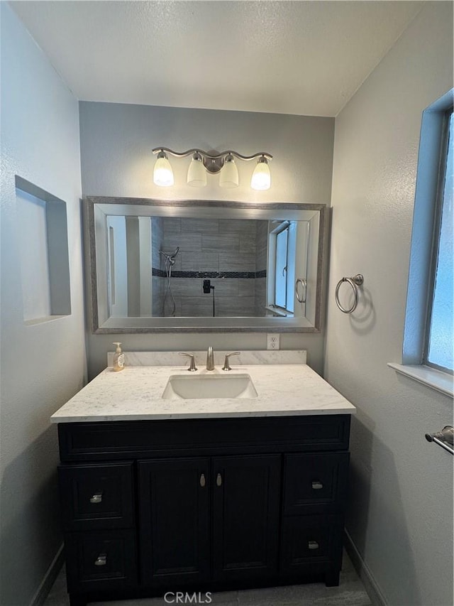 bathroom featuring vanity and a tile shower