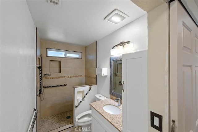 full bathroom with vanity, toilet, a walk in shower, and visible vents