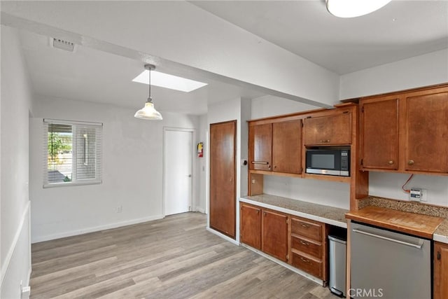 kitchen featuring dishwasher, light wood-style flooring, brown cabinetry, and black microwave