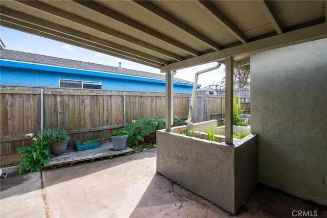 view of patio / terrace featuring a vegetable garden and fence