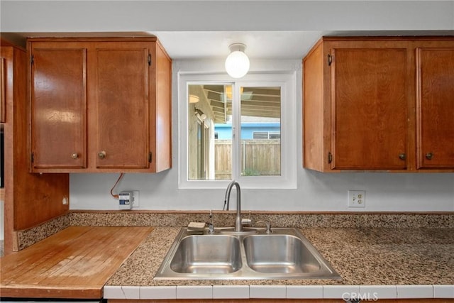 1429 14th St, Los Osos, CA 93402 - kitchen featuring a sink, brown cabinetry, and light countertops