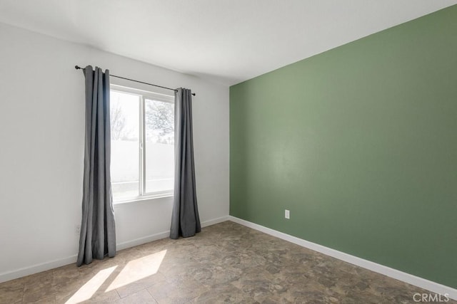 empty room featuring baseboards