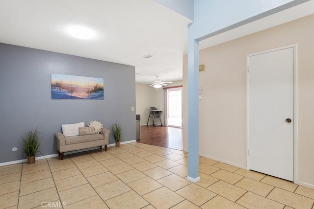 interior space featuring light tile patterned floors and baseboards