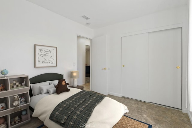 bedroom featuring a closet and visible vents