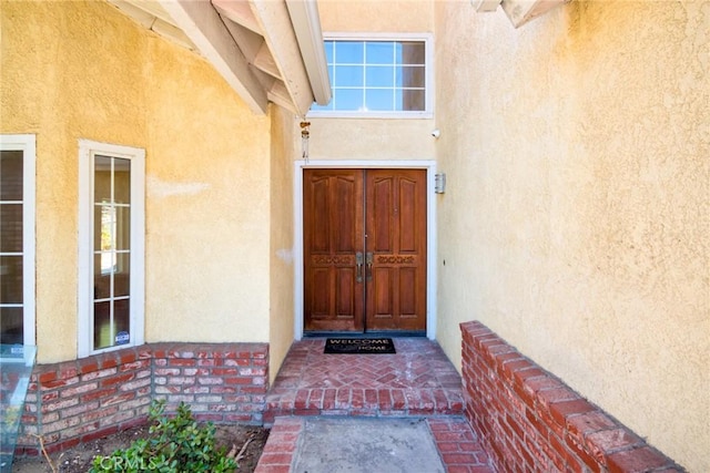 doorway to property with stucco siding