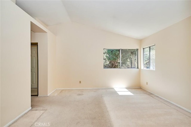 unfurnished room with baseboards, carpet floors, and vaulted ceiling