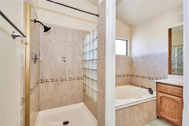 full bath featuring a tile shower, vanity, and a bath