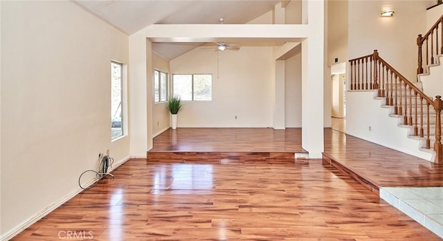 entryway featuring stairway, high vaulted ceiling, ceiling fan, and wood finished floors