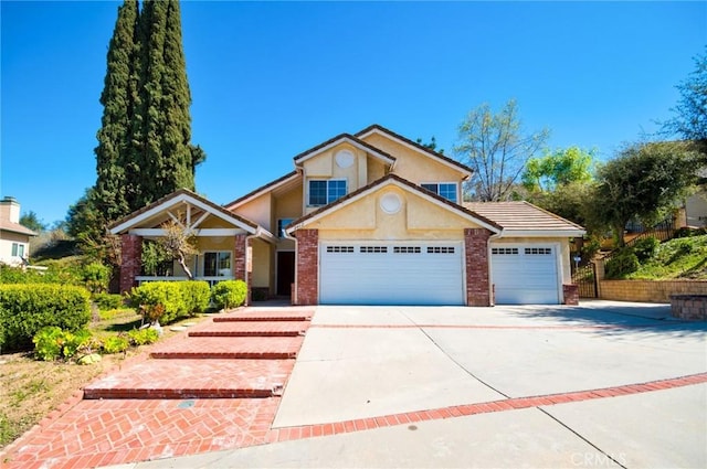 view of front of house with brick siding, stucco siding, concrete driveway, and a garage