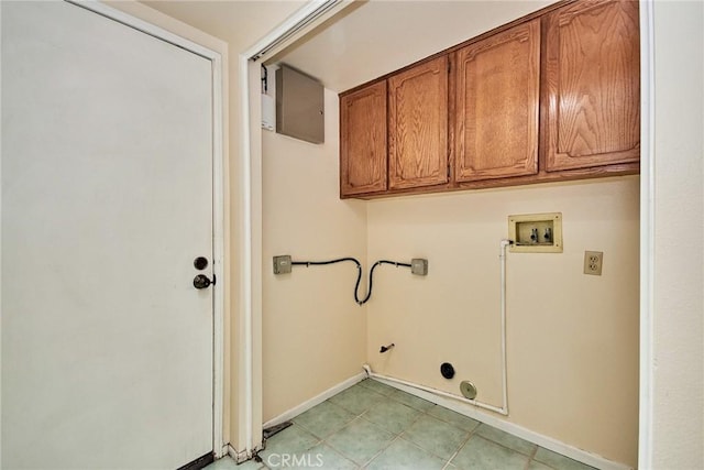 clothes washing area featuring baseboards, gas dryer hookup, light tile patterned floors, hookup for a washing machine, and cabinet space