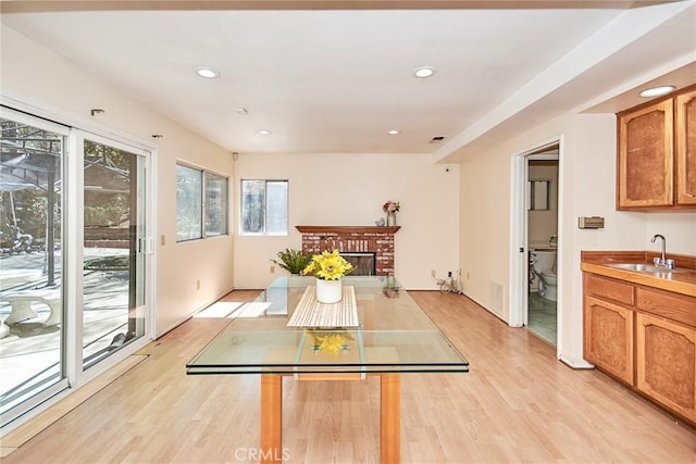 interior space with recessed lighting, visible vents, light wood-style floors, and a brick fireplace