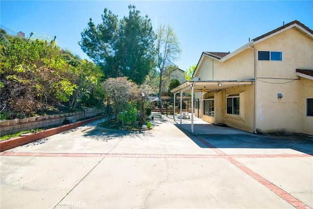 exterior space featuring a patio area and stucco siding