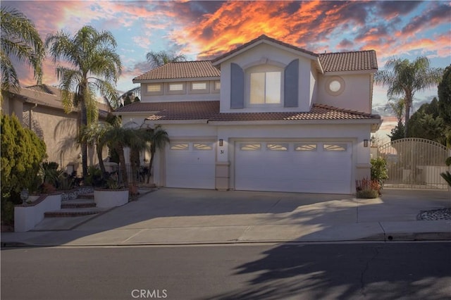 mediterranean / spanish-style house featuring stucco siding and driveway