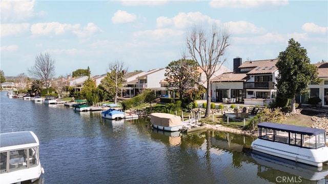 dock area featuring a residential view and a water view