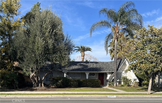 ranch-style house featuring stucco siding and a shingled roof