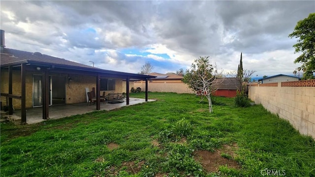 view of yard with a patio area and a fenced backyard