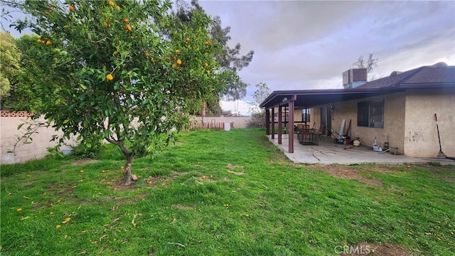 view of yard featuring central AC unit, a patio, and fence