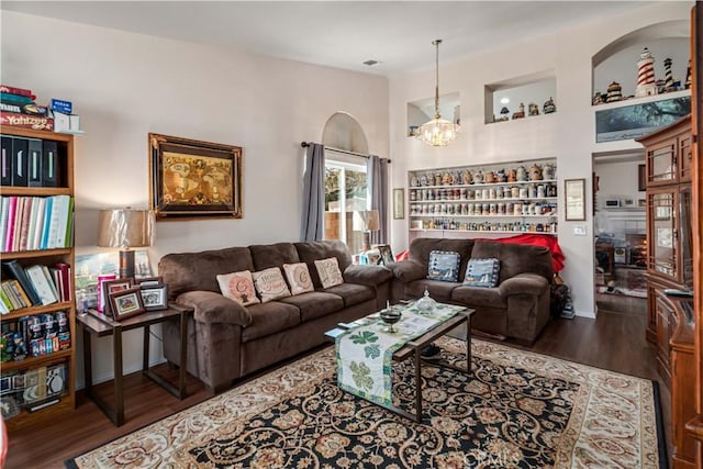 living room with a chandelier and wood finished floors