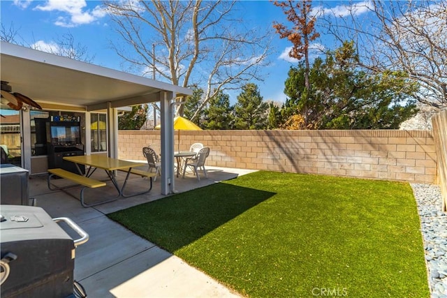 view of yard featuring fence and a patio area