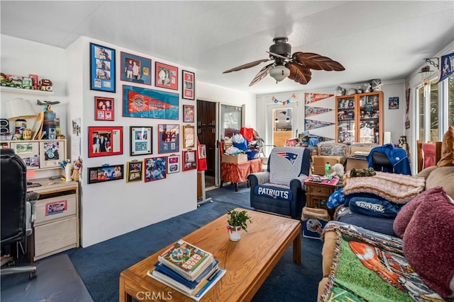 living area with carpet and ceiling fan