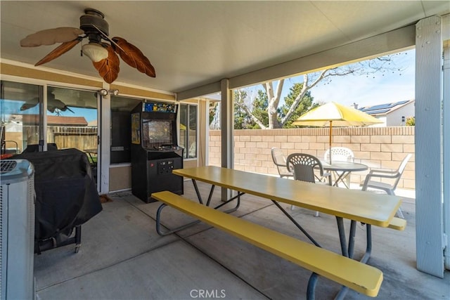 view of patio featuring outdoor dining space and fence