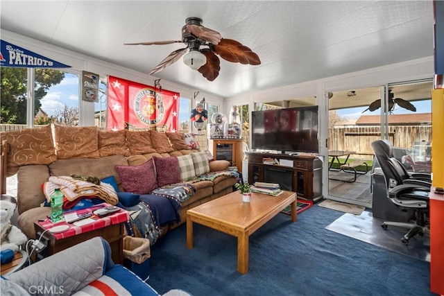 living area featuring a ceiling fan and a wealth of natural light