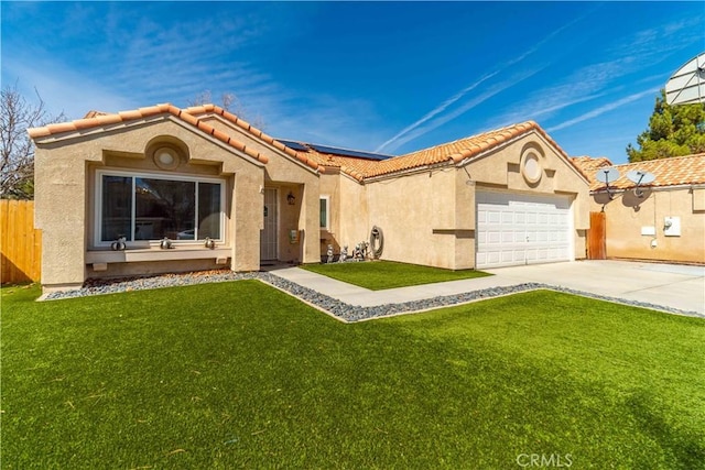 mediterranean / spanish home with a front yard, roof mounted solar panels, and stucco siding