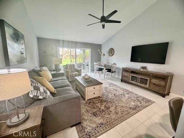 living area with a ceiling fan and high vaulted ceiling