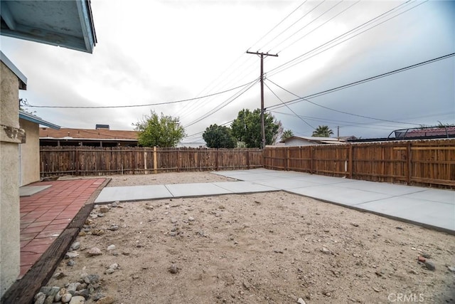 view of yard featuring a patio area and a fenced backyard