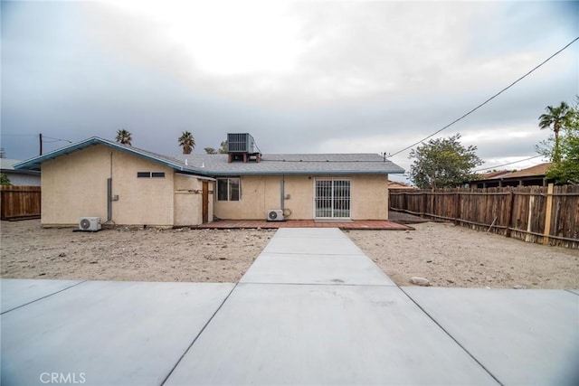 back of house with a patio area, stucco siding, cooling unit, and fence private yard