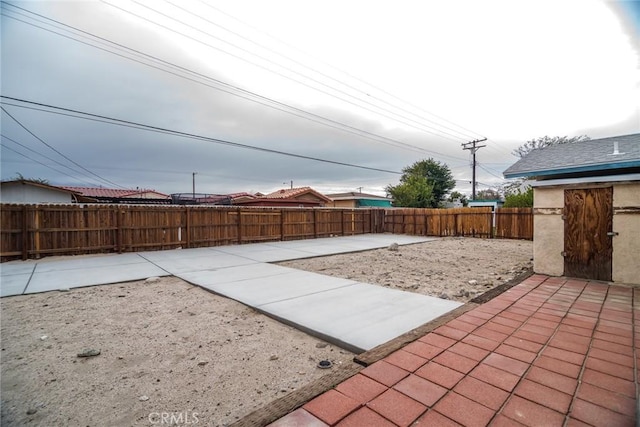 exterior space with a fenced backyard and a patio area