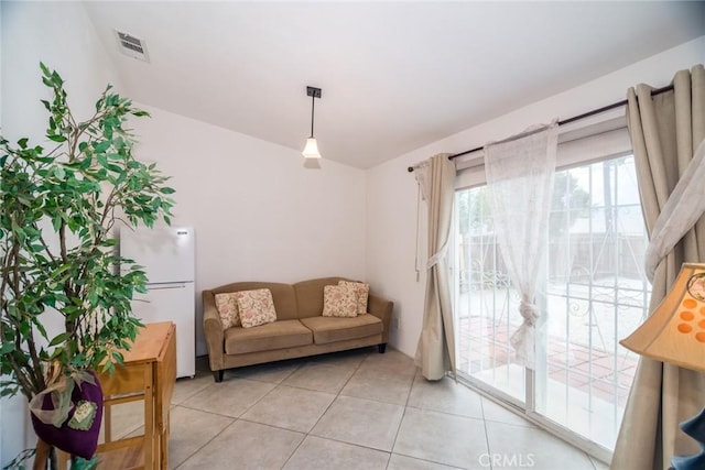 sitting room featuring light tile patterned floors and visible vents