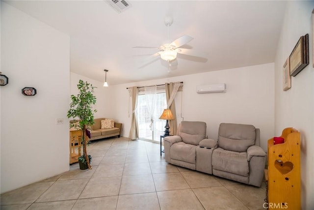 living area featuring light tile patterned floors, visible vents, an AC wall unit, and a ceiling fan