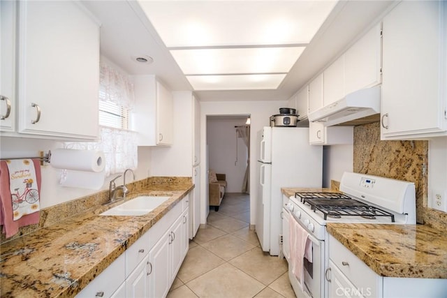 kitchen with under cabinet range hood, white appliances, white cabinets, and a sink