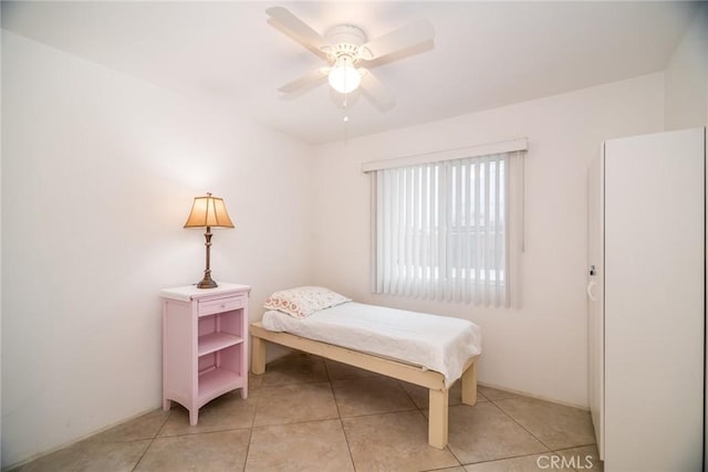 bedroom featuring light tile patterned floors and ceiling fan