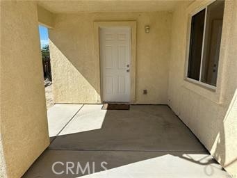 view of exterior entry with stucco siding