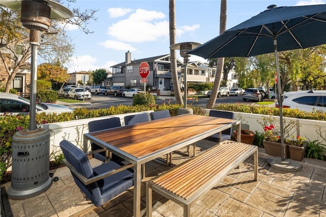 view of patio / terrace featuring outdoor dining space and a residential view