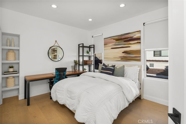 bedroom with recessed lighting, baseboards, and wood finished floors