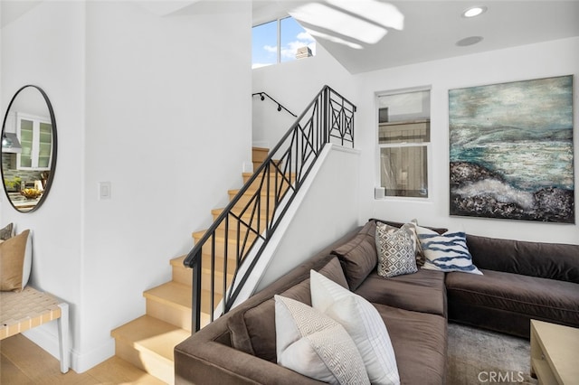 living room featuring stairway, recessed lighting, wood finished floors, and baseboards