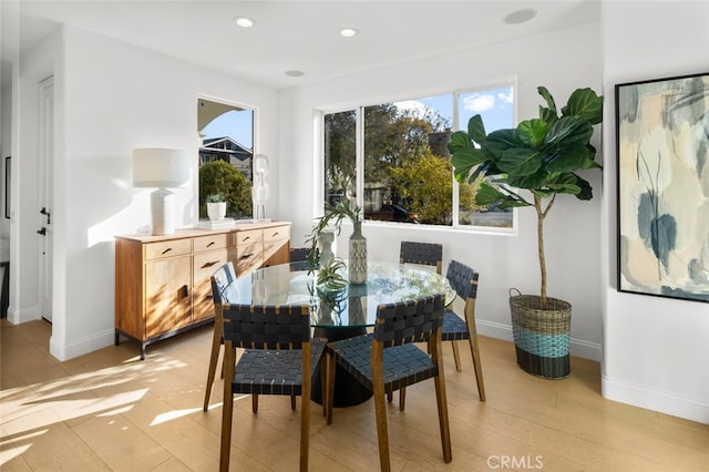 dining area featuring recessed lighting, baseboards, and light wood-type flooring