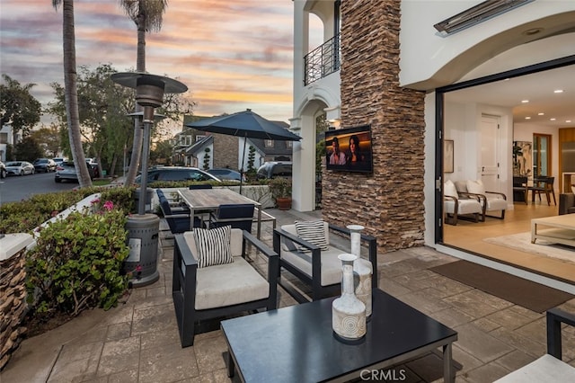 view of patio terrace at dusk