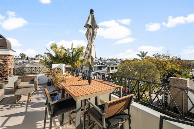 view of patio / terrace featuring a balcony and outdoor dining space