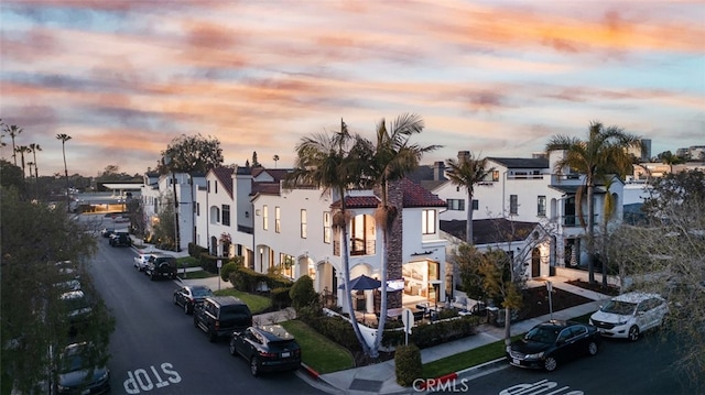 property at dusk featuring a residential view