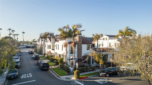 view of road featuring curbs, a residential view, and sidewalks